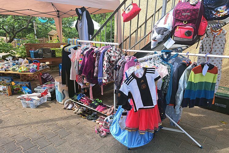 Flohmarktstand mit Spielzeug, Kleidung, Schuhen, etc.